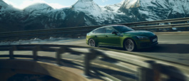 Audi RS5 driving on a bridge in the alps